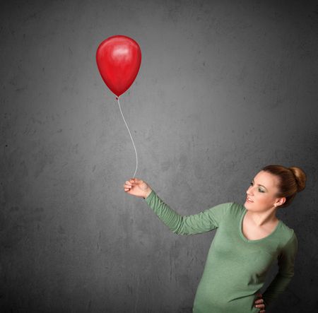 Young woman holding a red balloon drawing