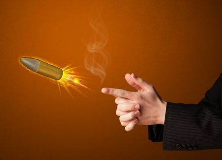 Gun shaped male hand with bullet coming out of it