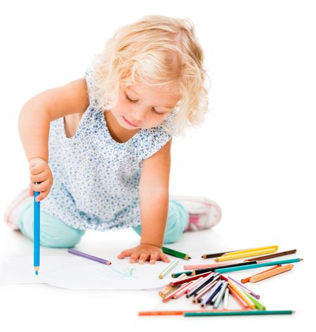 Girl drawing on the floor with color pencils - isolated over white 