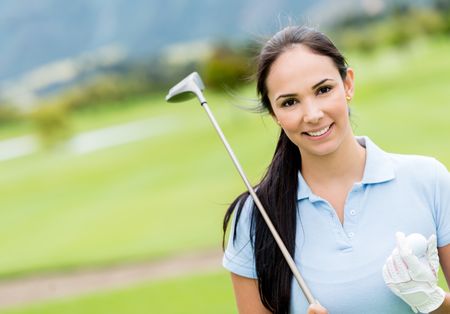 Female golf player at the course looking very happy 
