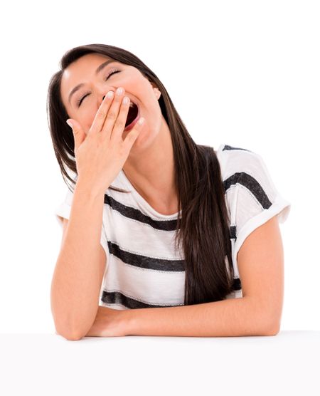 Lazy woman yawning - isolated over a white background