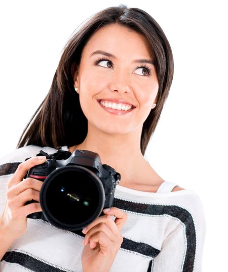 Thoughtful female photographer holding a camera - isolated over white 