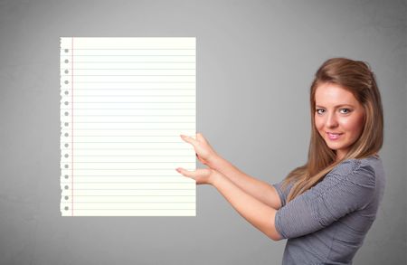 Pretty young lady holding white paper copy space with diagonal lines