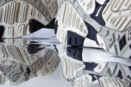 Soles of running shoes and their reflections