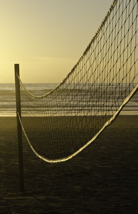 Beach volleyball net at sunset along Pacific coast of Oregon