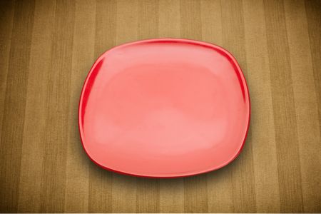 Colorful empty shiny plate on grungy background table 