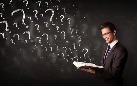 Confused man reading a book with question marks coming out from it