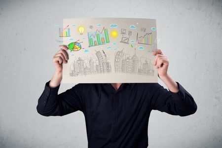 Businessman holding a paper in front of his head with charts and cityscape drawing