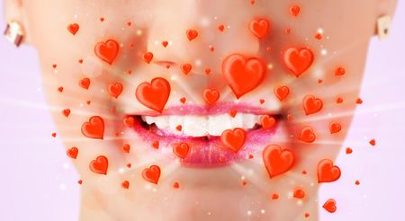 Pretty lady lips with lovely red hearts close up