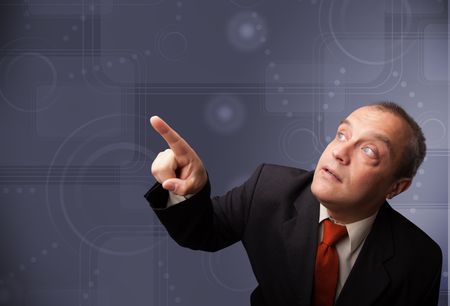 Elegant businessman standing and touching copy space