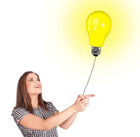 Happy young woman holding a light bulb balloon