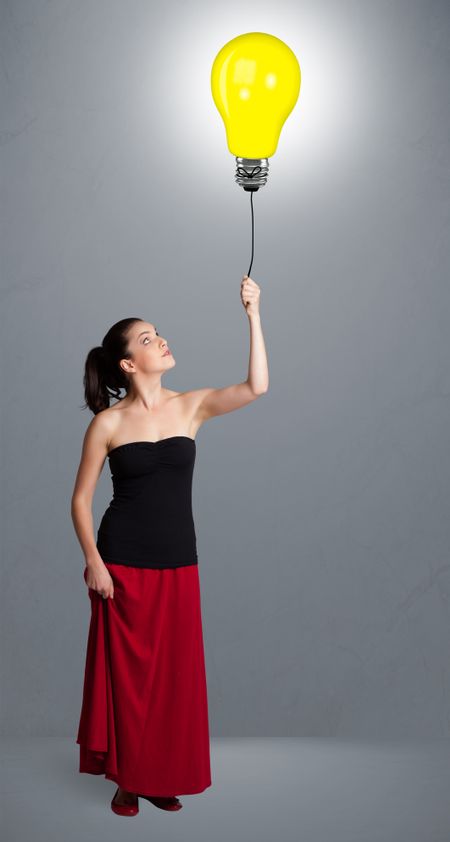 Pretty young woman holding a light bulb balloon
