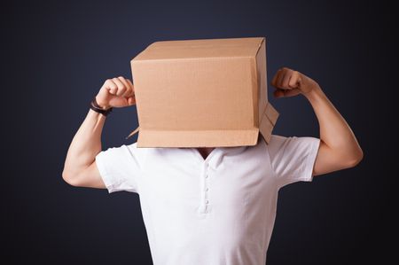 Young man standing and gesturing with a cardboard box on his head