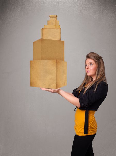 Attractive young lady holding a set of brown cardboard boxes