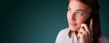 Young woman standing and making phone call with copy space