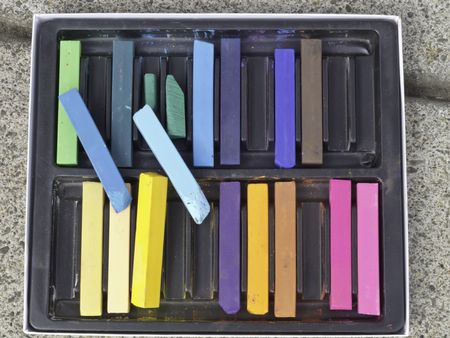 Box of chalk sticks for decoration of sidewalks and streets at urban art festival