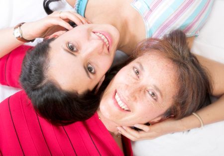 mother and daughter on the floor with heads together, soft focus