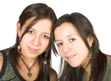 beautiful twin sisters over a white background