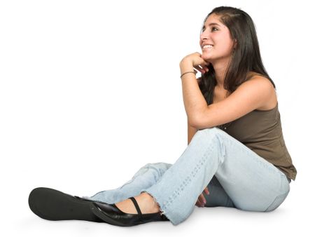pensive teenager on the floor looking aside - over white background
