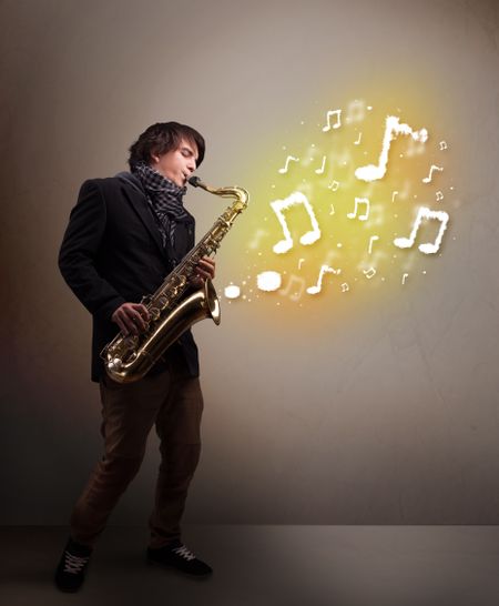 Handsome young musician playing on saxophone with musical notes