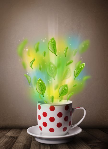 Tea cup with leaves and colorful abstract lights, close up