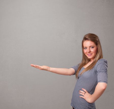 Pretty young woman presenting an empty copy space