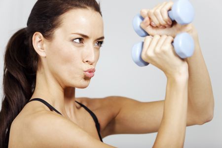Woman training with dumbbells