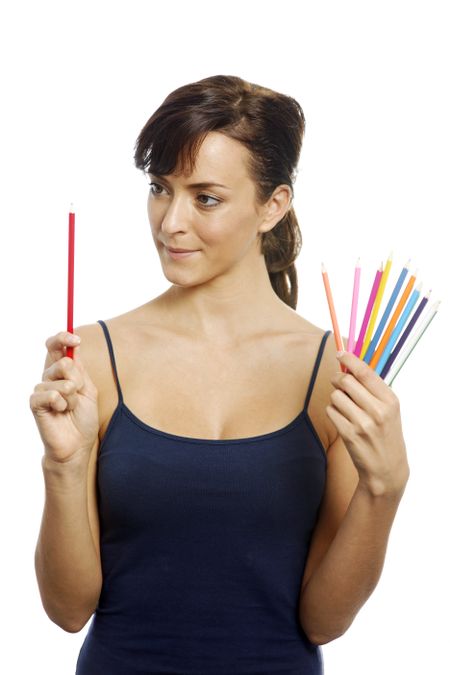 Young woman holding an assortment of colouring pencils