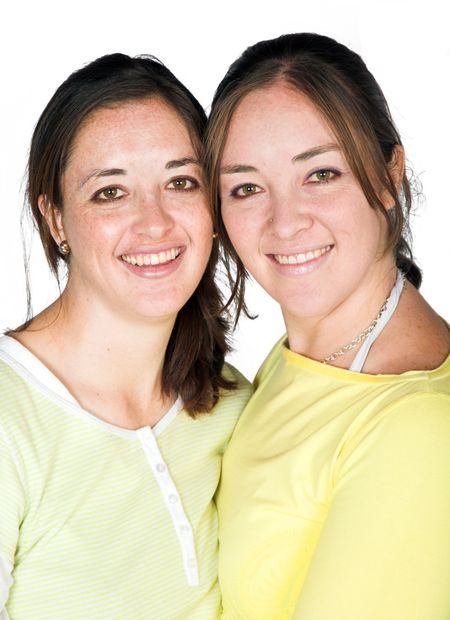 casual happy sisters over a white background