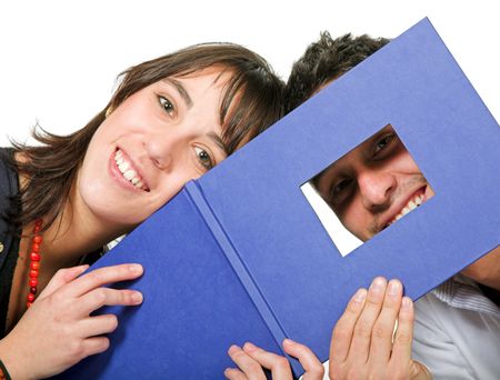 couple of students with photobook over a white background