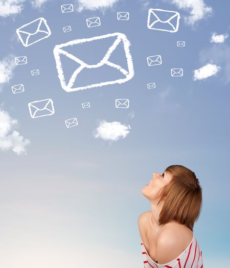 Casual young girl looking at mail symbol clouds on blue sky