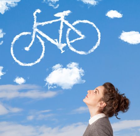 Young casual girl looking at bicycle clouds on blue sky