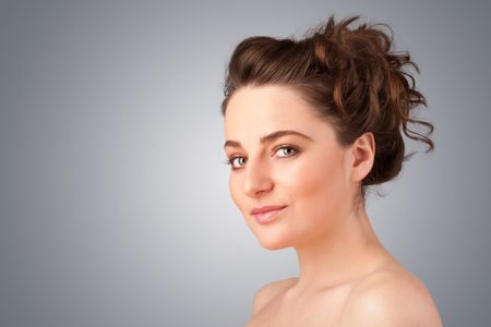 Close up portrait of beautiful young naked girl on gradient background