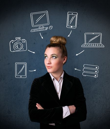 Thoughtful young woman with multimedia icons around her head