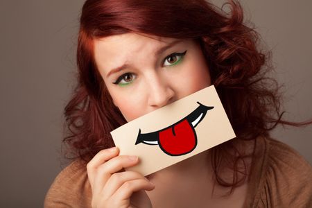 Happy pretty woman holding card with funny smiley on gradient background