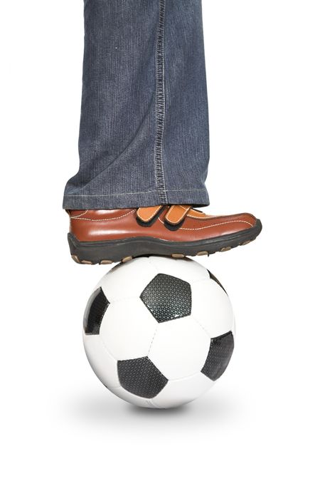 leg stepping onto a football on a white background
