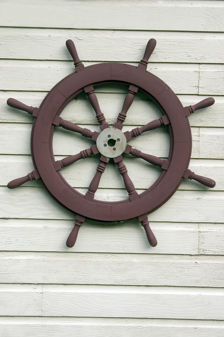 Riverboat steering wheel on exterior wall
