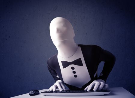 Man without identity working with keyboard and mouse on blue background