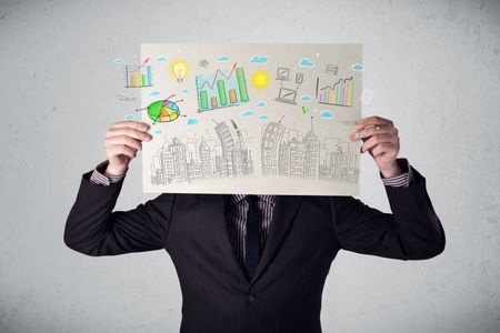 Businessman holding a paper in front of his head with charts and cityscape drawing