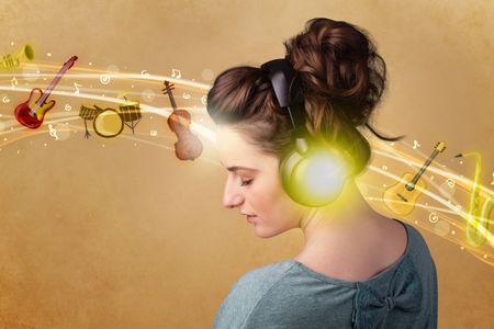 Pretty young woman with headphones listening to music, instruments concept