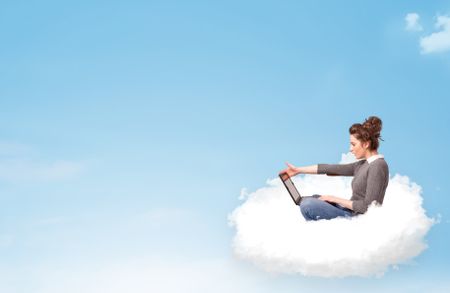 Pretty young woman with laptop sitting on cloud with empty space