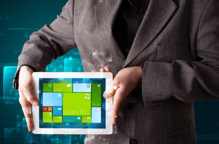 Young businessman holding a tablet with modern software operational system