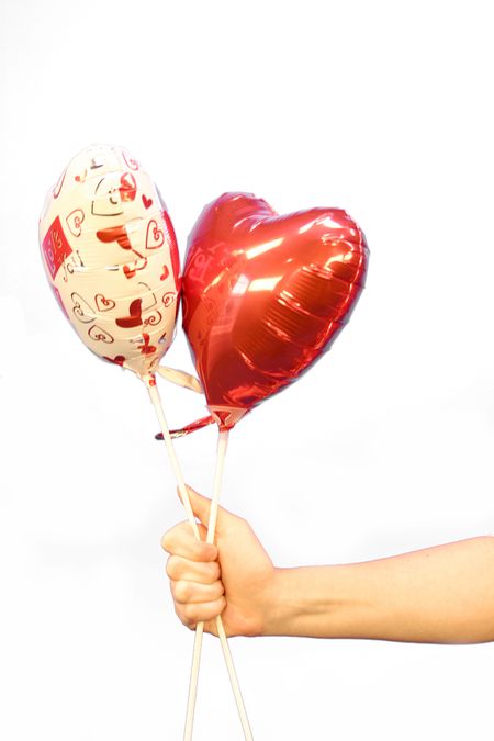 Hand holding 2 hearts