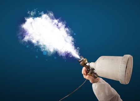 Painter with airbrush gun and white magical smoke concept