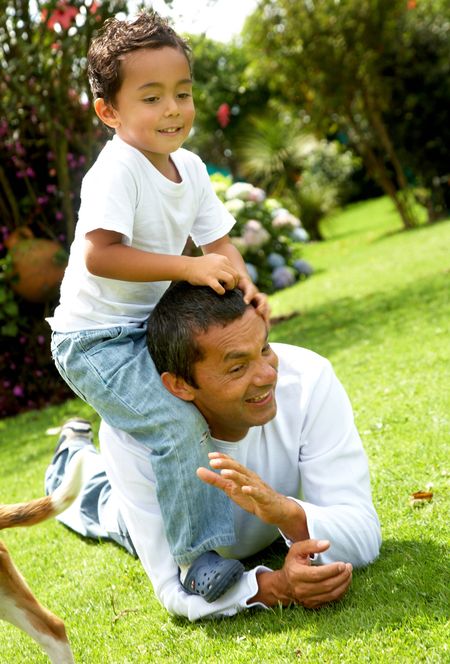 family lifestyle portrait of a dad with his son having fun outdoors