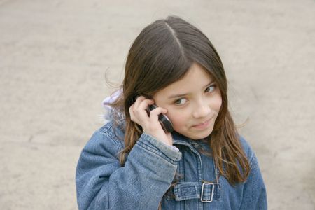 beautiful little girl talking on the phone