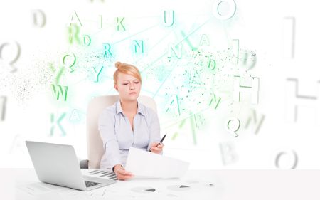 Business woman at white desk with green word cloud