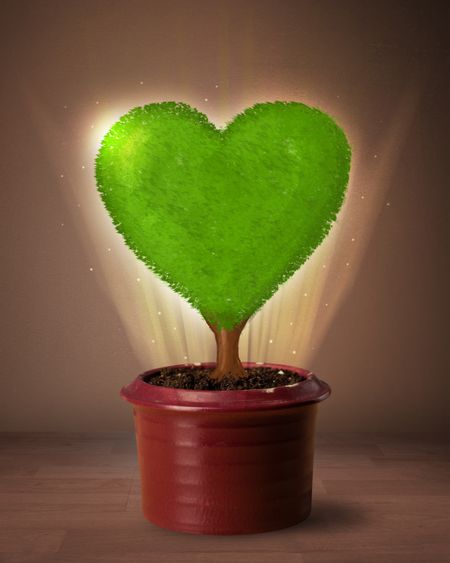 Glowing eco love tree coming out from flowerpot