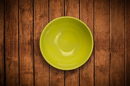 Colorful empty shiny plate on grungy background table 