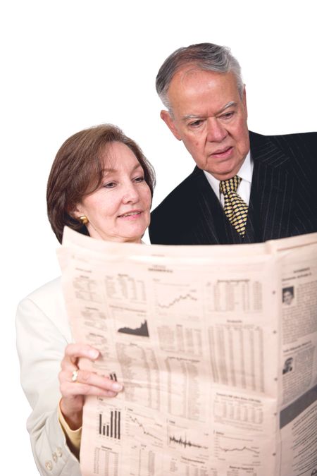 business partners reading financial paper over white